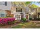 Charming townhouse exterior with brick accents and manicured landscaping at 7707 Falcon Rest Cir, Raleigh, NC 27615