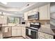 Modern kitchen featuring granite countertops, stainless steel appliances, and ample storage space at 7707 Falcon Rest Cir, Raleigh, NC 27615