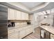Open concept kitchen with granite countertops and stainless steel appliances overlooks the dining area at 7707 Falcon Rest Cir, Raleigh, NC 27615