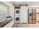 Functional laundry area with stacked washer and dryer and a window seat at 7707 Falcon Rest Cir, Raleigh, NC 27615