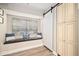 Cozy living area featuring a cushioned window seat, barn door, and built in storage at 7707 Falcon Rest Cir, Raleigh, NC 27615