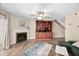 Cozy living area with a fireplace, built-in shelving, and a staircase to the upper level at 7707 Falcon Rest Cir, Raleigh, NC 27615