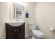 Stylish powder room with a modern sink vanity and toilet at 7707 Falcon Rest Cir, Raleigh, NC 27615