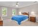 Spacious bedroom with neutral carpet, ceiling fan and an abundance of natural light from two large windows at 8309 Nantahala Dr, Raleigh, NC 27612