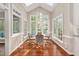 Sun-filled breakfast nook surrounded by windows offering picturesque views of the outdoors at 8309 Nantahala Dr, Raleigh, NC 27612