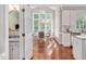 Sunlit breakfast nook with hardwood floors, large windows, and seating area at 8309 Nantahala Dr, Raleigh, NC 27612