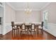 Formal dining room with hardwood floors, chandelier, and classic wainscoting at 8309 Nantahala Dr, Raleigh, NC 27612