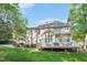 House exterior with deck, manicured lawn and many windows at 8309 Nantahala Dr, Raleigh, NC 27612