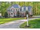 Beautiful brick home with lush green lawn and long driveway at 8309 Nantahala Dr, Raleigh, NC 27612