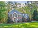 Imposing red brick home with blue shutters and well maintained lawn at 8309 Nantahala Dr, Raleigh, NC 27612