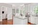 Open kitchen with island flows into the bright breakfast nook with backyard views at 8309 Nantahala Dr, Raleigh, NC 27612