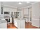Modern kitchen with stainless steel appliances, white cabinets, and granite island offers ample counter space at 8309 Nantahala Dr, Raleigh, NC 27612