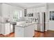 Modern kitchen with stainless steel appliances, granite countertops, and white cabinetry at 8309 Nantahala Dr, Raleigh, NC 27612