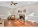 Inviting living room showcases a brick fireplace with decorative mantel and ample natural light at 8309 Nantahala Dr, Raleigh, NC 27612