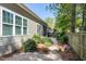 Landscaped backyard with a stone path and wooden fence at 837 Varina Ln, Fuquay Varina, NC 27526