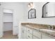 Bathroom with double vanity, granite counters, and vintage-style mirrors at 837 Varina Ln, Fuquay Varina, NC 27526
