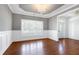 Formal dining room boasts an elegant chandelier, gray walls, and plantation shutters at 837 Varina Ln, Fuquay Varina, NC 27526