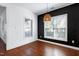 Bright dining room features contemporary lighting and a black accent wall at 837 Varina Ln, Fuquay Varina, NC 27526