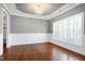Dining room with decorative wainscoting, trey ceiling, and elegant chandelier at 837 Varina Ln, Fuquay Varina, NC 27526