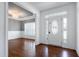 Inviting foyer with stained wood floors, chandelier, and view to formal dining at 837 Varina Ln, Fuquay Varina, NC 27526