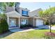 Attractive brick home with a manicured lawn, colorful shrubbery, and two-car garage at 837 Varina Ln, Fuquay Varina, NC 27526