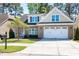 Lovely brick home boasts a two-car garage, beautiful landscaping, and well-kept lawn at 837 Varina Ln, Fuquay Varina, NC 27526