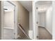 Hallway with stairs and two open doors to rooms with hardwood flooring at 837 Varina Ln, Fuquay Varina, NC 27526