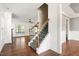 Open concept living area featuring hardwood floors, ceiling fan, and staircase at 837 Varina Ln, Fuquay Varina, NC 27526