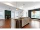 Open kitchen features an island with granite countertop, stainless steel appliances at 837 Varina Ln, Fuquay Varina, NC 27526