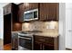 The kitchen features stainless steel appliances, granite countertops, and dark cabinetry at 837 Varina Ln, Fuquay Varina, NC 27526