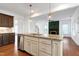 Open kitchen features an island with granite countertop, stainless steel appliances at 837 Varina Ln, Fuquay Varina, NC 27526