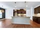 Open kitchen features an island with granite countertop, stainless steel appliances at 837 Varina Ln, Fuquay Varina, NC 27526
