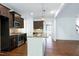 Open kitchen features an island with granite countertop, stainless steel appliances at 837 Varina Ln, Fuquay Varina, NC 27526