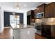 Kitchen features an island with granite countertop, stainless steel appliances at 837 Varina Ln, Fuquay Varina, NC 27526