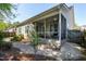 View of the screened porch, with a swing, and well-kept landscaping surrounding the property at 837 Varina Ln, Fuquay Varina, NC 27526