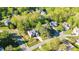 Aerial view of the home situated amongst mature trees at 906 Ingram Ct, Hillsborough, NC 27278