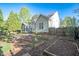 Landscaped backyard with raised garden beds, a screened-in porch and patio at 906 Ingram Ct, Hillsborough, NC 27278