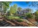 The backyard is landscaped and has a screened-in porch at 906 Ingram Ct, Hillsborough, NC 27278