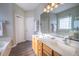 Bathroom featuring dual sinks, a large mirror, and a soaking tub at 906 Ingram Ct, Hillsborough, NC 27278