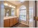 Bathroom with a framed window, and wooden cabinets at 906 Ingram Ct, Hillsborough, NC 27278