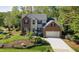 Charming two-story brick home with a well-manicured lawn and attached two-car garage at 906 Ingram Ct, Hillsborough, NC 27278