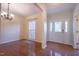 Bright foyer with hardwood floors, chandelier, and window trimmed in molding at 906 Ingram Ct, Hillsborough, NC 27278