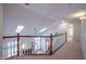 Hallway features a skylight and overlooks the living room below at 906 Ingram Ct, Hillsborough, NC 27278