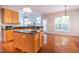 Open kitchen and dining area with hardwood floors and bright natural light at 906 Ingram Ct, Hillsborough, NC 27278