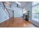 Open living space with vaulted ceilings, large windows, a fireplace, and staircase at 906 Ingram Ct, Hillsborough, NC 27278