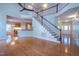 Inviting living room with hardwood floors, staircase, open kitchen, and soaring ceilings at 906 Ingram Ct, Hillsborough, NC 27278