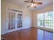 Office space featuring a ceiling fan, large window, and glass paneled doors at 906 Ingram Ct, Hillsborough, NC 27278