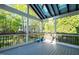 Screened in porch with black metal railings and two potted plants at 906 Ingram Ct, Hillsborough, NC 27278