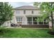 Expansive backyard with patio area, sunroom, well maintained lawn, and mature shade trees at 9225 Palm Bay Cir, Raleigh, NC 27617