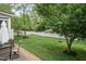 Picturesque backyard featuring a well-manicured lawn, patio seating, and a charming white picket fence at 9225 Palm Bay Cir, Raleigh, NC 27617